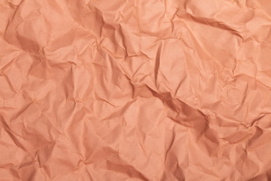 赪尾 — Close-up of crumpled orange paper ideal for backgrounds or textures with ample copy space.