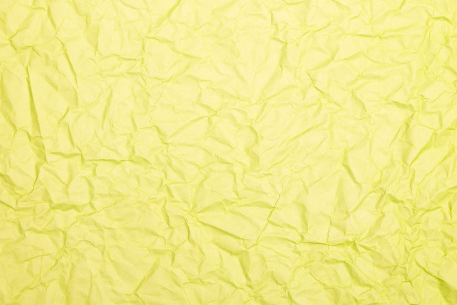 黄白游 — Crumpled yellow paper texture background with natural folds and wrinkles.