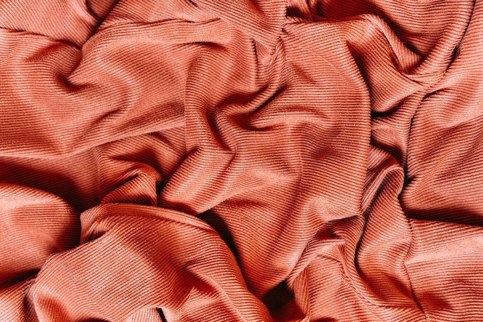 绛纱 — Intricate red fabric texture showing detailed material patterns and folds.