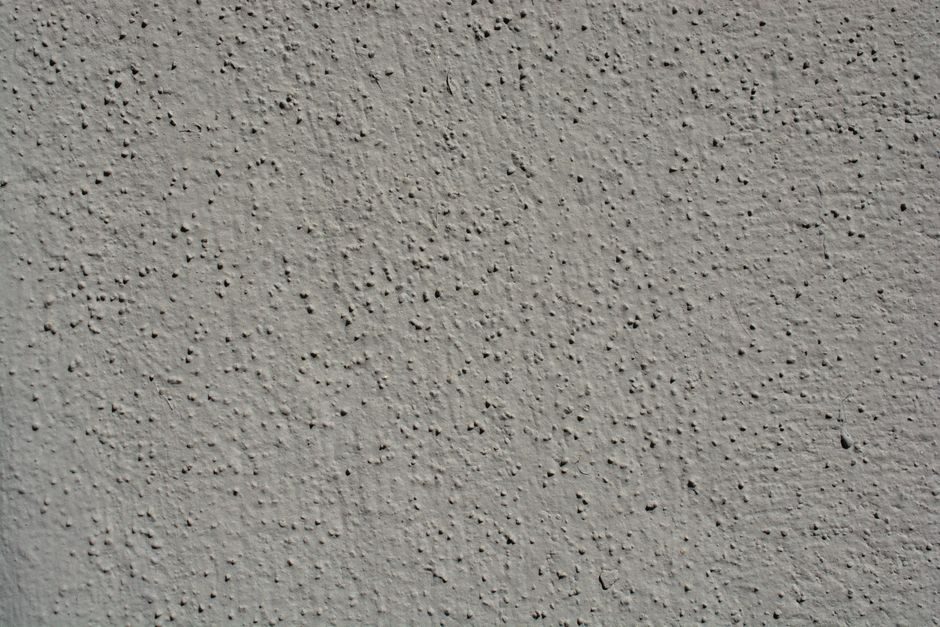青梅 — A close-up view showcasing the intricate texture of a gray stucco wall, perfect for backgrounds.